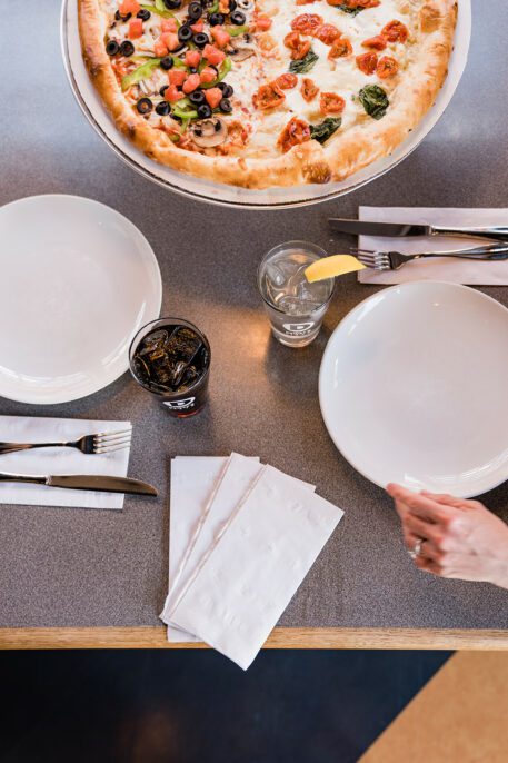 a table set with a large pizza