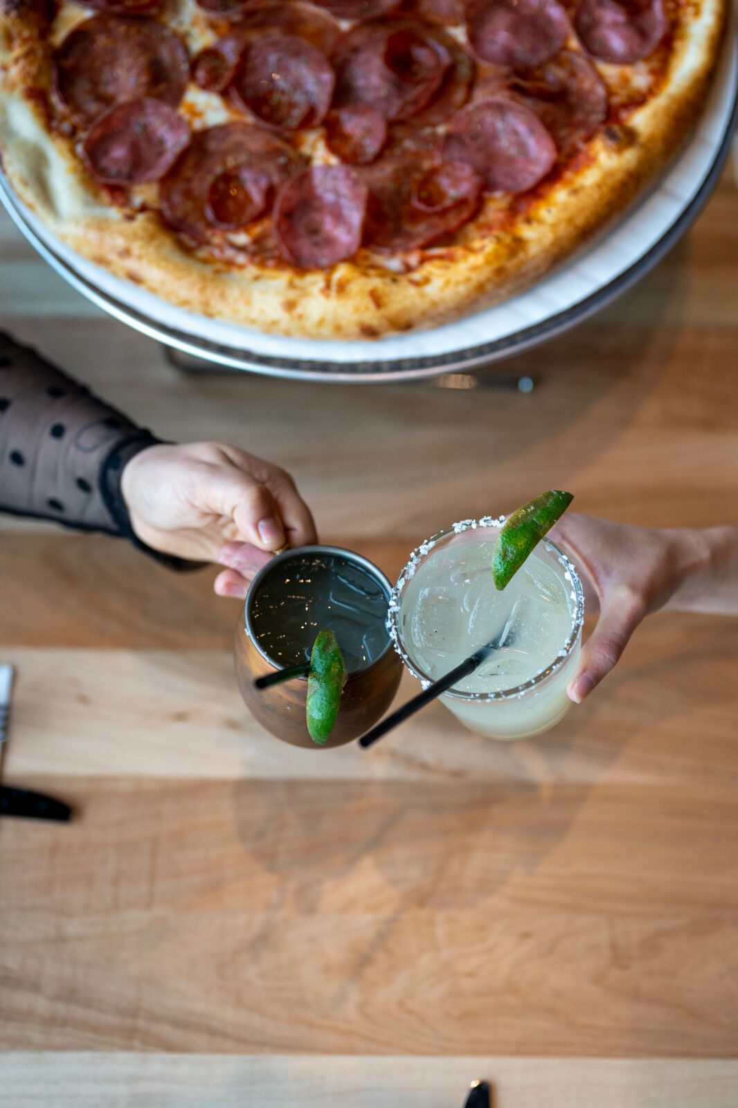 Friends enjoying a margarita and Moscow mule drink